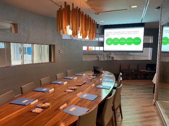 A workshop room prepared with notebooks around a shared table